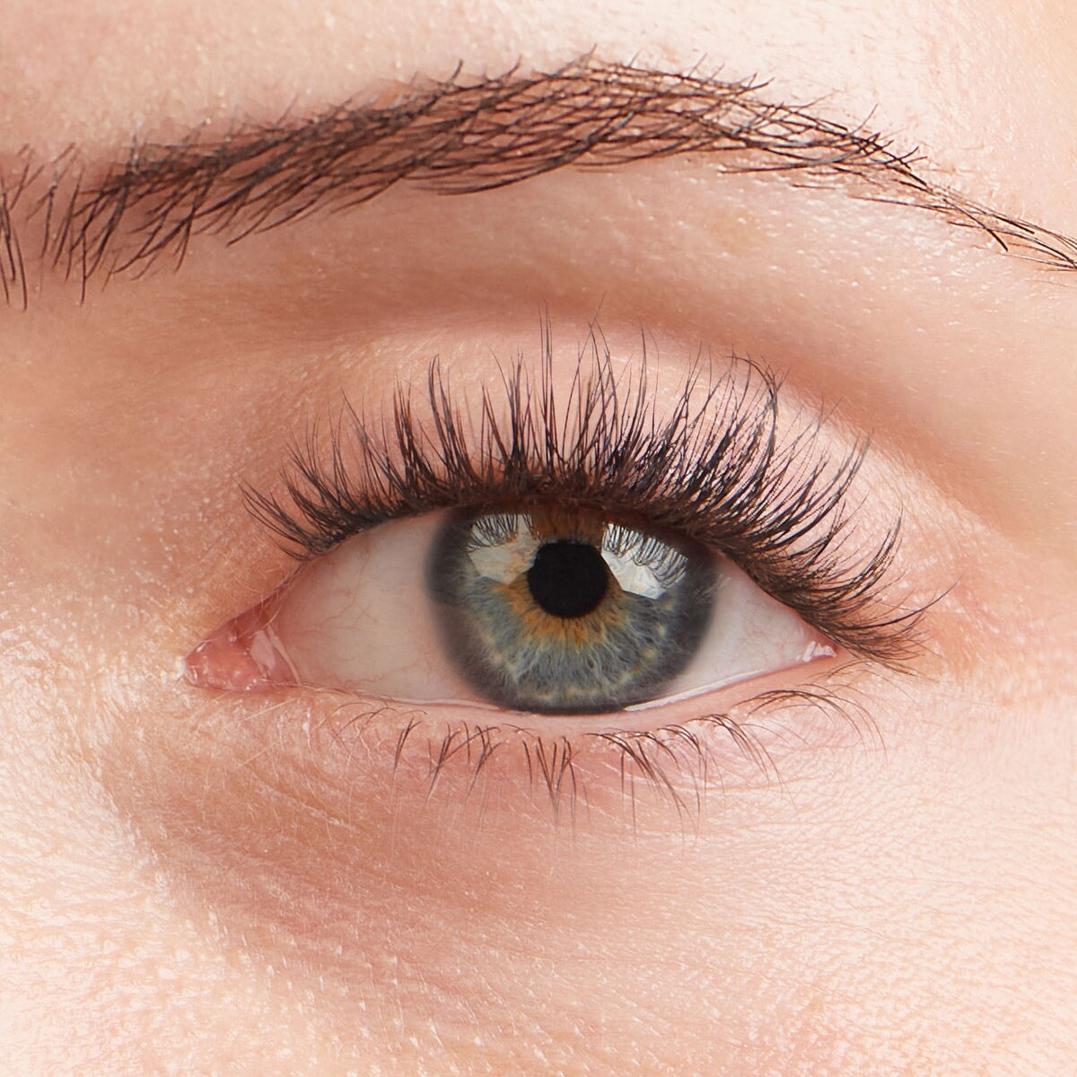 Aura NanoSoft lash clusters on a close-up of a blue-green eye, creating a lifted, natural look.