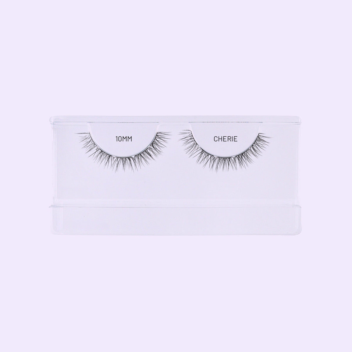 Lilac St. Cherie NanoSoft 10mm lash clusters arranged in a clear tray against a soft lilac background.