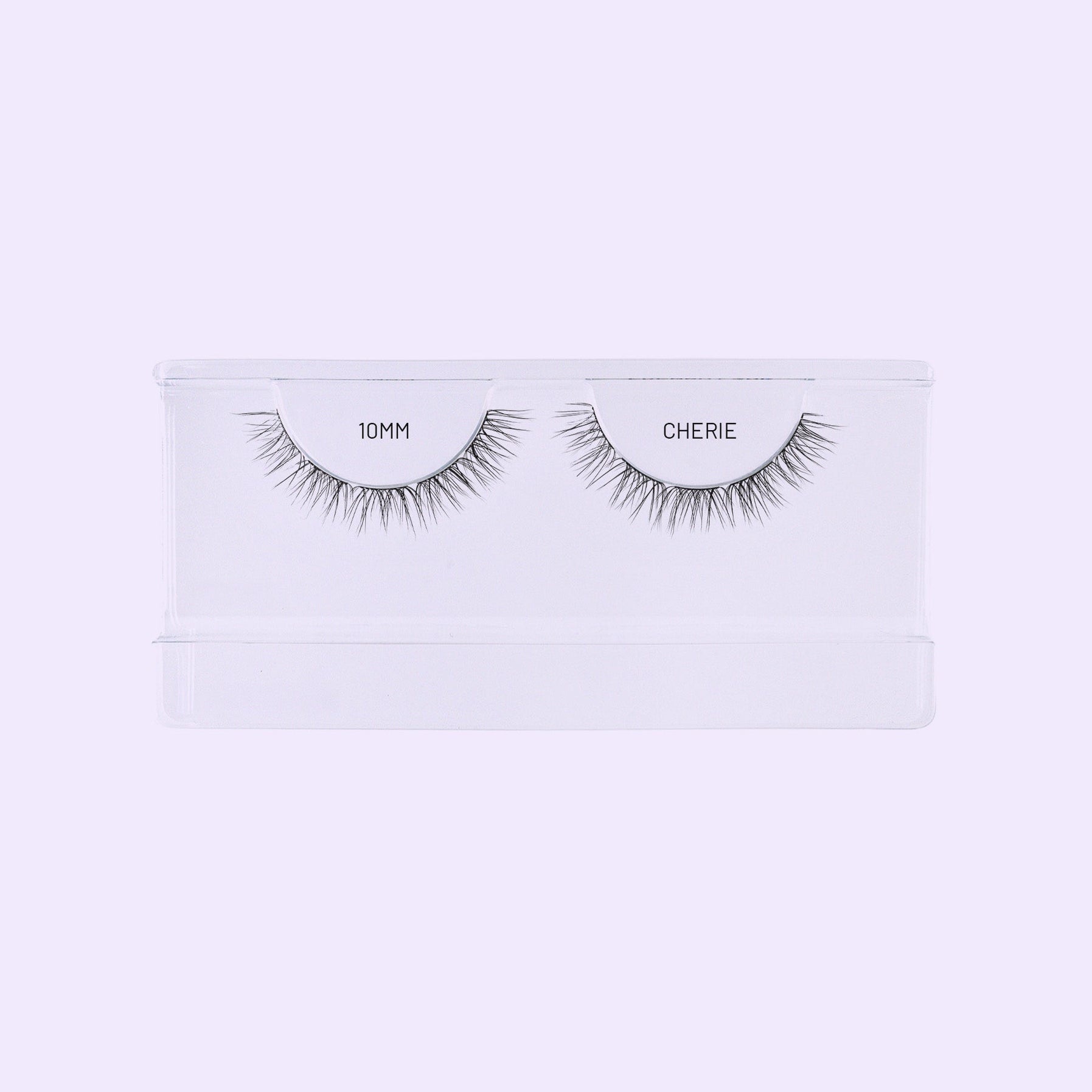 Lilac St. Cherie NanoSoft 10mm lash clusters arranged in a clear tray against a soft lilac background.