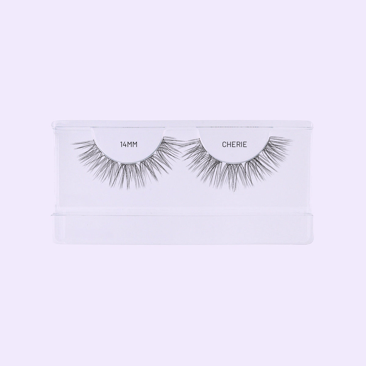 Lilac St. Cherie 14mm NanoSoft lash clusters arranged in a clear tray against a soft lilac background.