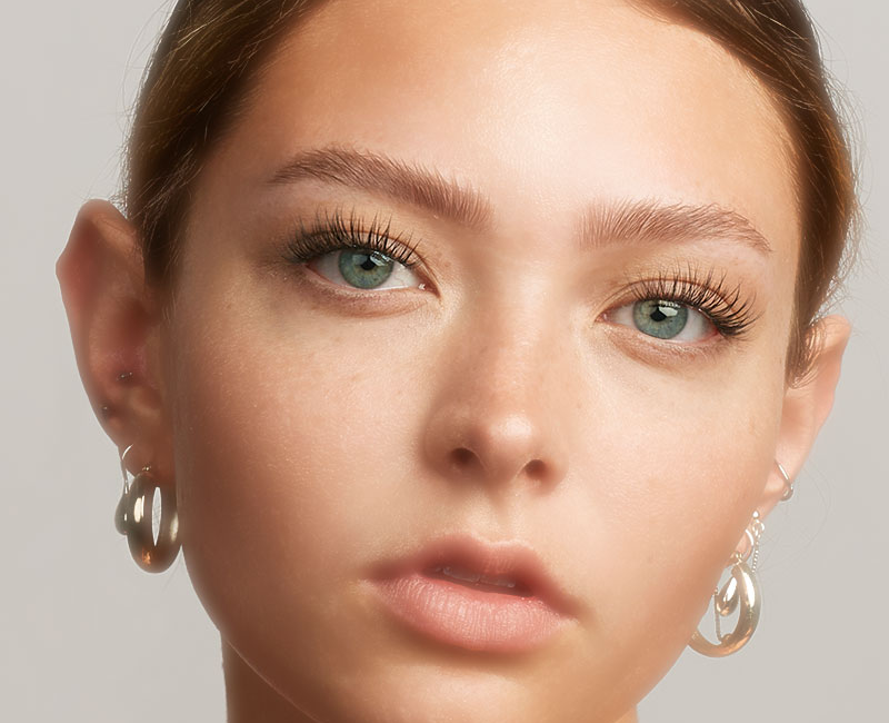 Close-up of a woman with Lilac St. lash clusters, showing natural-looking definition and a subtle lift.